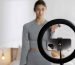 female-fitness-instructor-recording-herself-lifting-weights-home-with-smartphone-ring-light-min